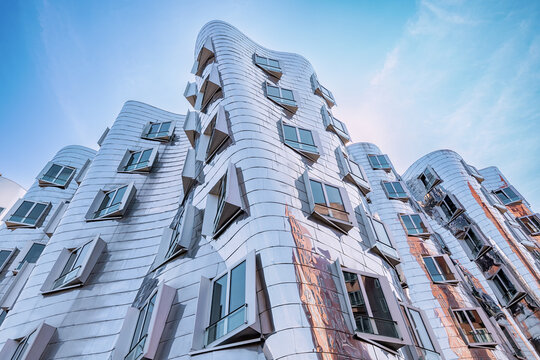 23 July 2022, Dusseldorf, Germany: Gehry Bauten or Zollhof unusual modern architecture buildings in Media Harbor. Dancing houses and travel attractions