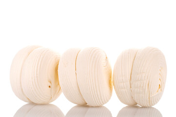 Three sweet white marshmallows, macro, isolated on white background.