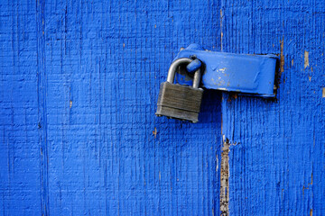 Lock on Hinge on Blue Door and Wall