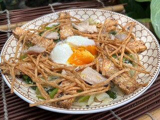 Crispy bar fish topping with soft egg