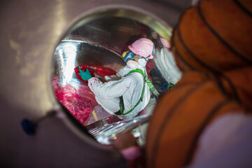 Top view male climbs up the stairs into the tank stainless chemical area confined space safety