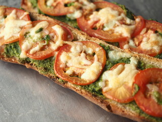 toasted baguette with pesto, tomato and mozzarella cheese