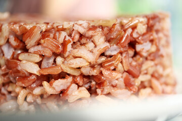 cooked red rice in a bowl on table , haradighi rice 