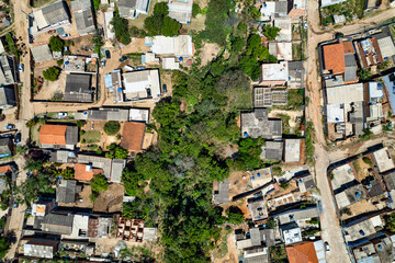 Fototapeta premium Aerial view of Parque Oziel neighborhood (also known as Jardim Monte Cristo) in Campinas, São Paulo. Poor community with wooden houses, garbage and vegetation in its surroundings.