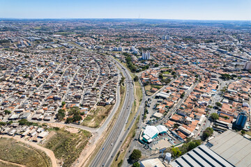 Fototapeta premium Aerial view of Parque Oziel neighborhood (also known as Jardim Monte Cristo) in Campinas, São Paulo. Poor community with wooden houses, garbage and vegetation in its surroundings.