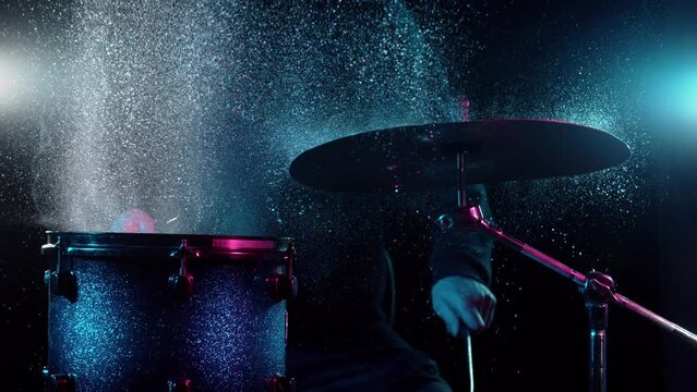 Super slow motion of drummer banging on cymbal and drum with water splashing. Filmed on high speed cinema camera , 1000 fps.