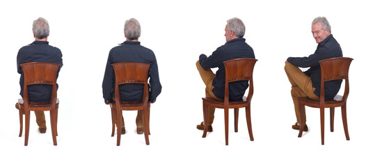 back view of same man sitting on chair turned and looking at camera on white background
