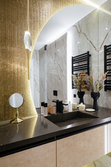 stylish and modern bathroom with a large mirror and lighting