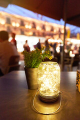 view of a wooden table on the terrace of a bar at night