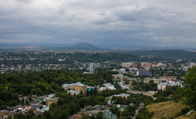 Fototapeta premium Panoramic top view of Pyatigorsk, Stavropol territory with residential buildings among green trees