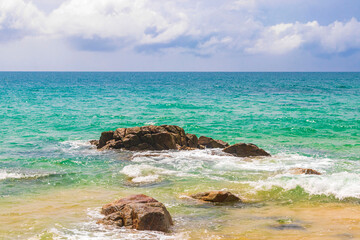 Naithon Beach bay turquoise clear water and waves Phuket Thailand.