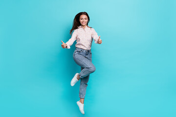 Photo of satisfied girl two arm demonstrate like cool symbol rejoice stylish outfit empty space isolated on aquamarine color background