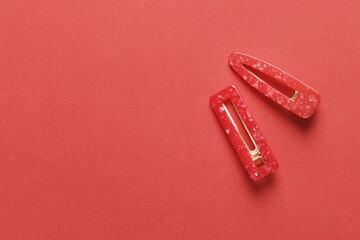 Fashionable, stylish colored hair clips on a colored background