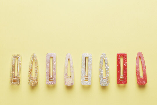 Fashionable, stylish colored hair clips on a colored background