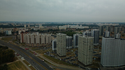 Construction site of a new city block. Construction of multi-storey buildings. Overcast weather. Aerial photography.
