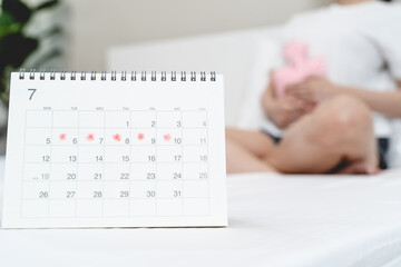 Monthly menstruation symptom period concept. Close up calendar marking on menstruation period day...