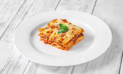 Portion of lasagne on white plate