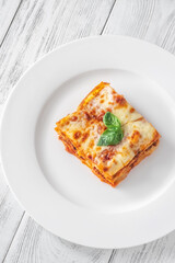 Portion of lasagne on white plate