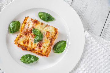 Portion of lasagne on white plate
