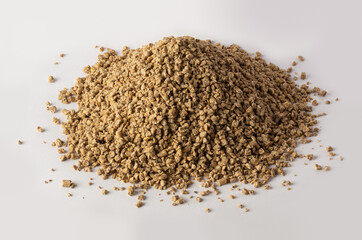 pile of chicken feed crumble, semi-loose variety made from pellets cracked into smaller pieces,...