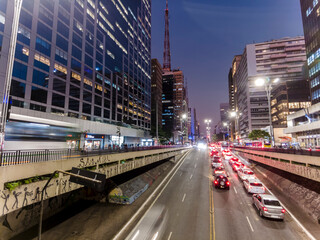 Fototapeta na wymiar Sao Paulo, Brazil September 01, 2022. Traffic of vehicles in Paulista Aveue at night in Sao Paulo city, Brazil
