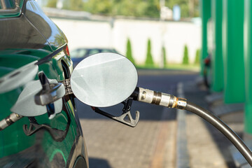 Fuel nozzle to refill fuel in car at gas station.