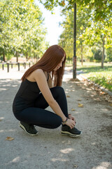 Female sporty fitness runner preparing to run outdoors