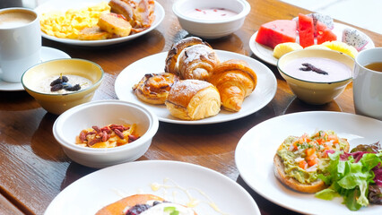 Wooden table full of various food in luxury restaurant, cafe breakfast 