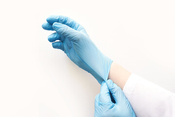 Fototapeta premium Put Medical glove. Surgery doctor hand. Medicine healthcare operation equipment. Specialist clean hospital arm. Sanitation protection gesture. Sterile hygiene concept. Blue color