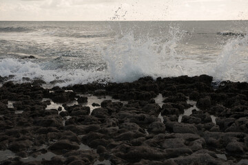 Ocean wave splashing over the stones