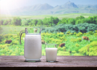 Fresh milk. Background image of mountains with fresh milk on table in countryside.