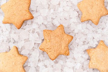 Top view of star shaped Christmas gingerbread cookies on pieces of ice background. Festive...