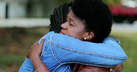 Obraz premium Depressed African woman, friend helping compassionate hug