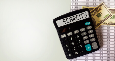 Calculator with SCARCITY text business concept, with dollar banknotes and documents on white background. Copy space
