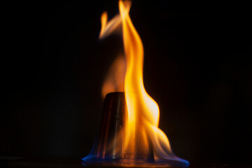 Flames in dark. Tongue of fire one. Alcohol flame retardation.