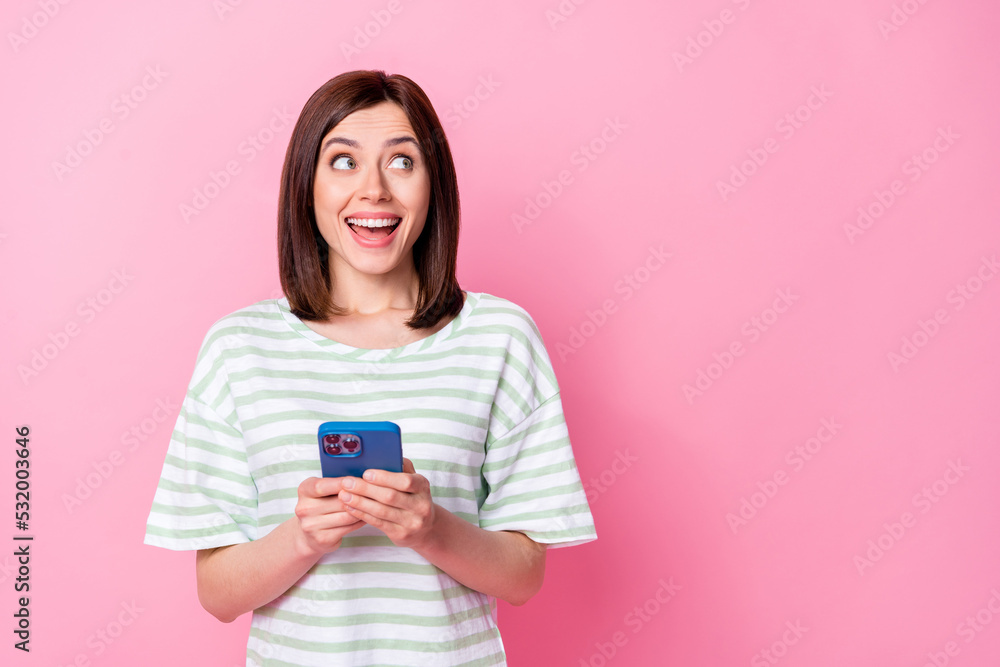 Sticker Photo of overjoyed cute stylish lady hand hold modern device gadget interested look empty space isolated on pink color background