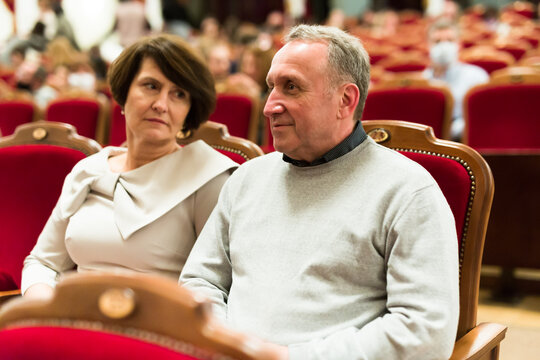 elderly couple watching play in the theater