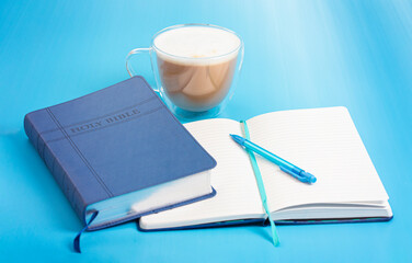 Holy Bible with a Notebook to Study on a Bright Background