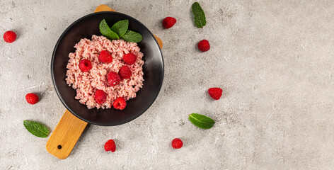 Obraz na płótnie Canvas risotto with raspberries and greek yogurt on grey background.