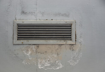 Air Vent Grille (Grid) on a Grey Wall for Ventilation