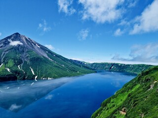 Naklejka na ściany i meble Russia, Kuril Islands, Sakhalin region. The nature of the Kamchatka Territory. Mountains and volcanoes surrounded by the Sea of Okhotsk and the ocean