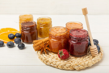 Jar of honey. Fruit honey with raspberries, blueberries, almonds and pistachios. Useful fortified jam for health and beauty. Honey cream. Vegetarian diet organic product. Copy space. - obrazy, fototapety, plakaty