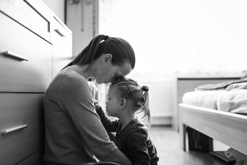 Portrait of mother taking care of child feeling tired stressed at home 