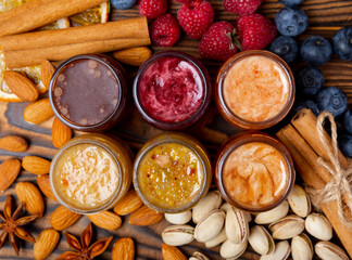 Jar of honey. Fruit honey with raspberries, blueberries, almonds and pistachios. Useful fortified jam for health and beauty. Honey cream. Vegetarian diet organic product. Copy space.