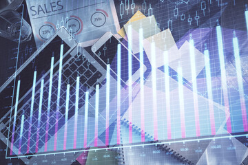 Financial market graph and top view computer on the desktop background. Multi exposure. Investment concept.