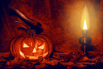 An evil pumpkin with a bloodied ax by the light of an old lamp in autumn foliage. Cool card for...