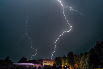 Lighting bolt over village school