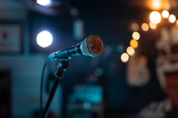 Close up of a classic microphone standing before a music show - obrazy, fototapety, plakaty