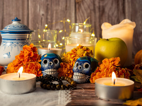Spanish Mexican traditional autumn festival day of the dead typical Mexican skull with flowers painted on wood background, decorations and marigold flowers