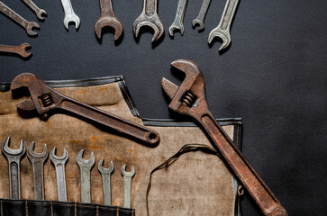 Vintage tool kit for repair and reconstruction at home lie on a black background
